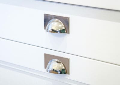 Chrome handles on a white cabinet drawer Kitchen design by Mangan Woodcraft