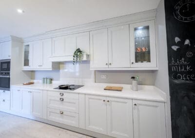 Mangan Woodcraft classic kitchen with ornate white presses and brass handles